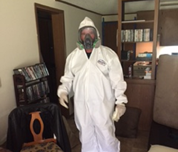 Tech in PPE for mold remediation